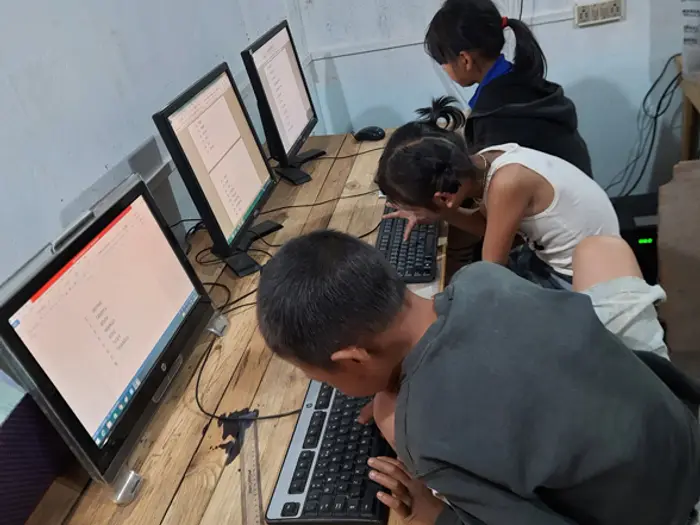 Students working on desktop computers, Educere Learning Center