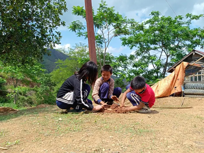 Children and a teacher doing an activity outdoors on the grounds, Educere Learning Center