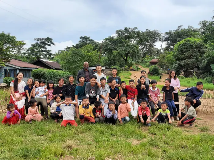 Children, teachers and families gathered on the lawn at the Educere Learning Center, Educere Learning Center
